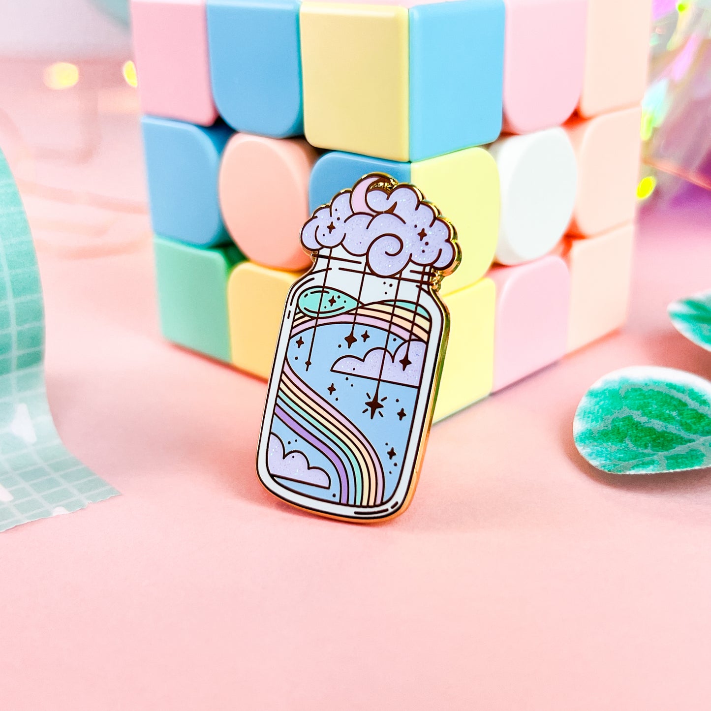 Angled view of the Imagination Potion Pin against pink and mint background
