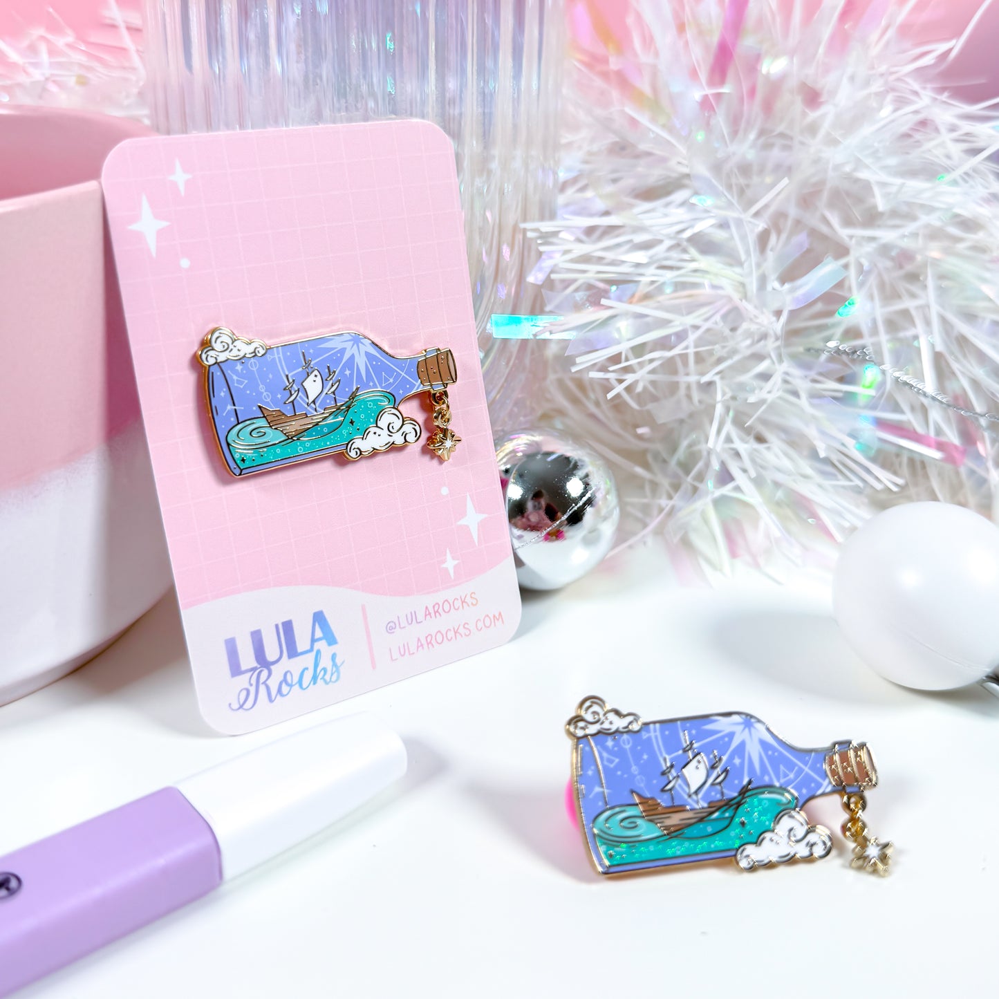 Ship in a Bottle enamel pin lifestyle display with props