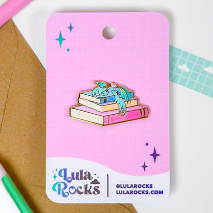 Lula Rocks enamel pin on a pink card with stationery items in the background