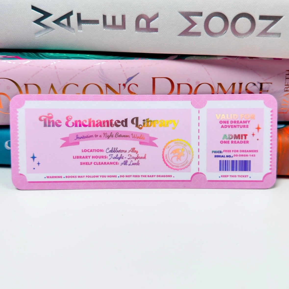 Ticket-style product packaging with 'The Enchanted Library' design on a white background