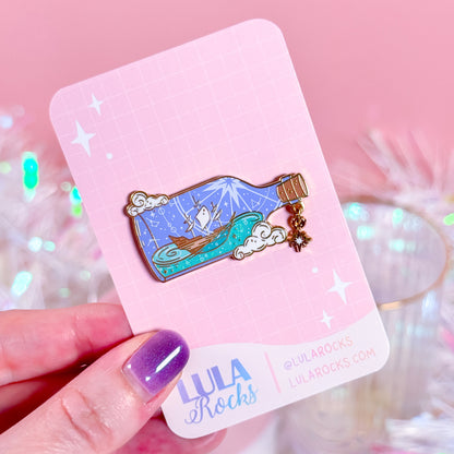 Ocean-inspired Ship in a Bottle enamel pin, perfect for navigating life's challenges