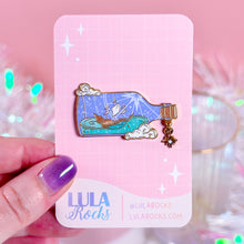 Load image into Gallery viewer, Close-up of Ship in a Bottle hard enamel pin with screen printing and glittery sea