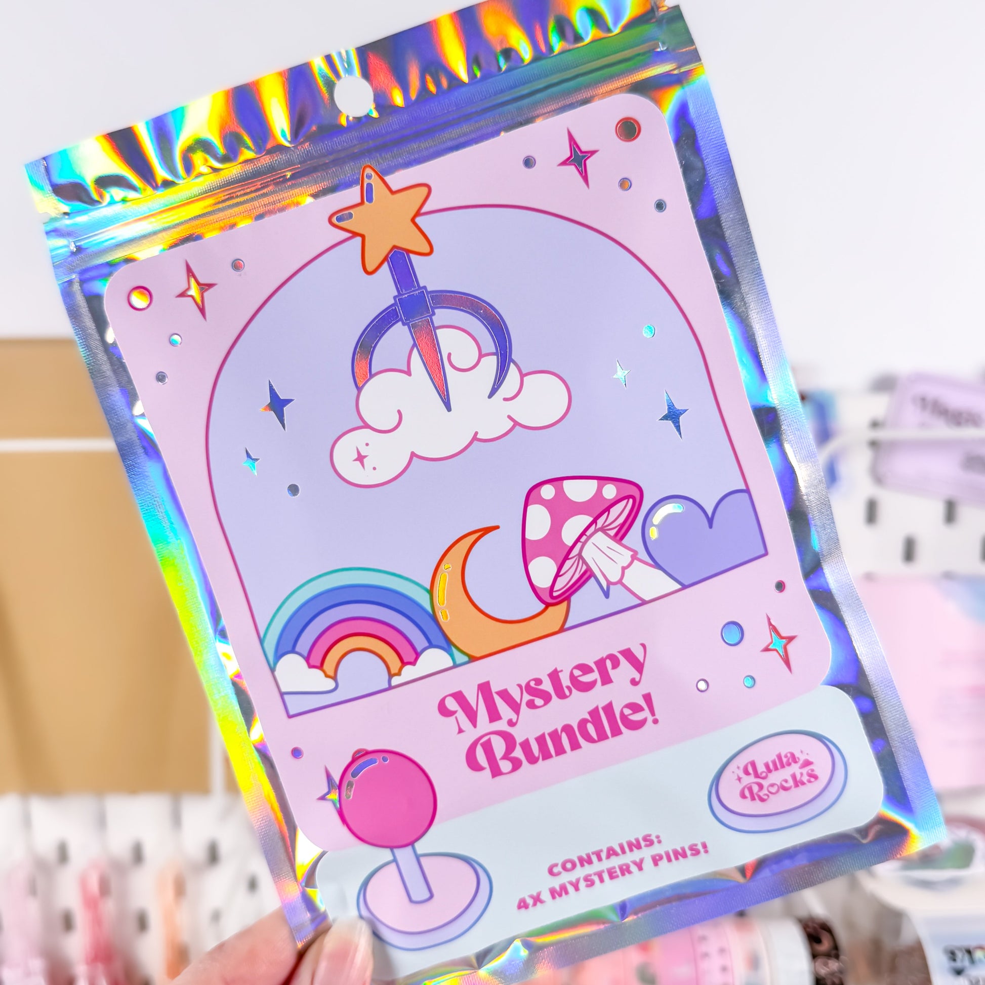 Holographic packaging of a 'Mystery Bundle' with colorful designs on a blurred background.